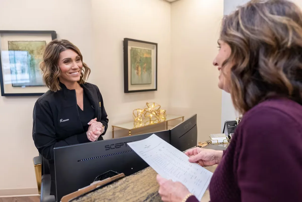 A Smile Center team member helping a patient at the front desk
